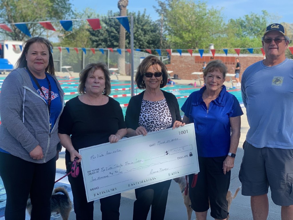 The board presenting a $5,000 donation to the Sharks Swim team.